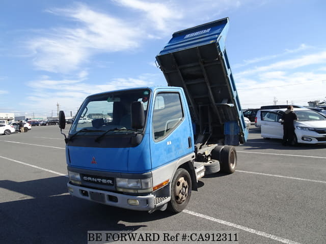 A grey JDM sports car speeding down a highway at night.