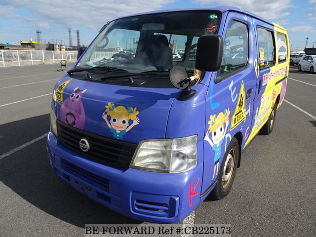 A grey JDM sports car speeding down a highway at night.