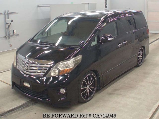 A grey JDM sports car speeding down a highway at night.