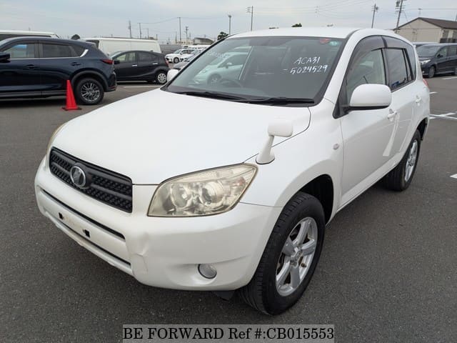 A grey JDM sports car speeding down a highway at night.