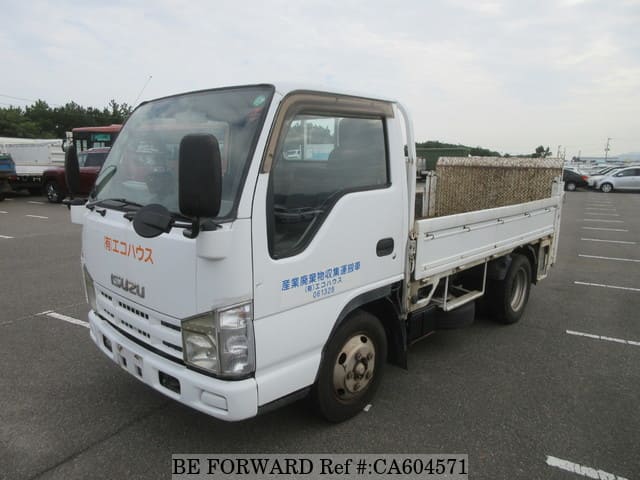 A grey JDM sports car speeding down a highway at night.