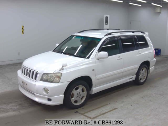 A grey JDM sports car speeding down a highway at night.
