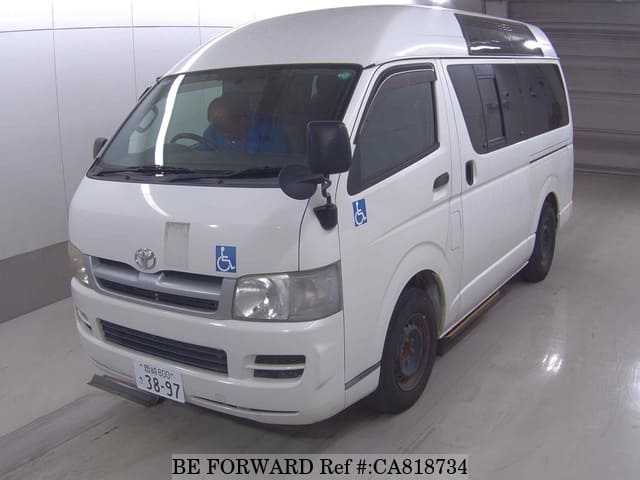 A grey JDM sports car speeding down a highway at night.