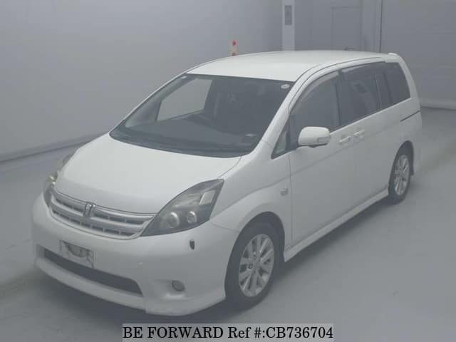 A grey JDM sports car speeding down a highway at night.