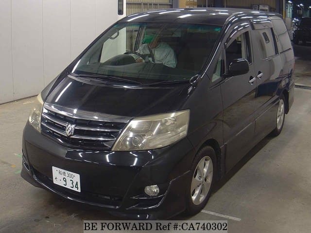 A grey JDM sports car speeding down a highway at night.