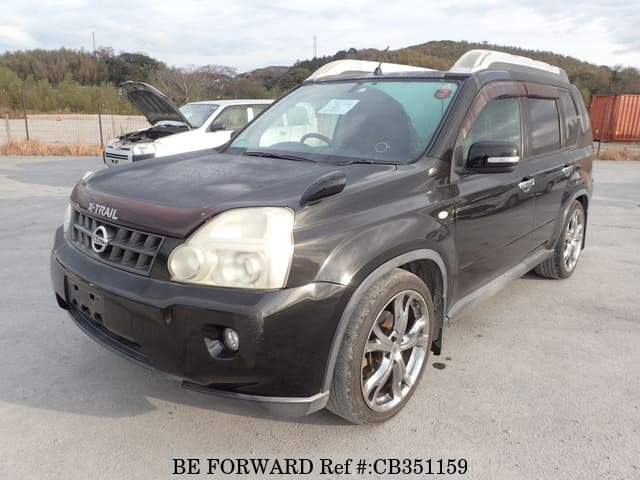 A grey JDM sports car speeding down a highway at night.