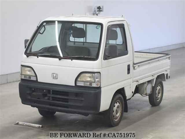 A grey JDM sports car speeding down a highway at night.