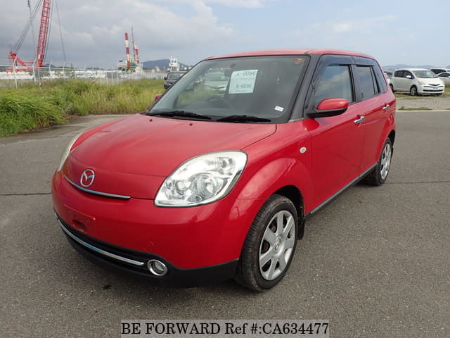 A grey JDM sports car speeding down a highway at night.