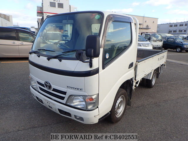 A grey JDM sports car speeding down a highway at night.