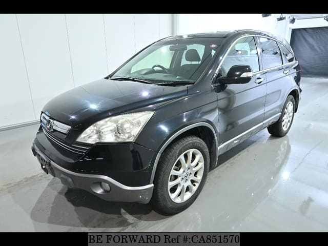 A grey JDM sports car speeding down a highway at night.