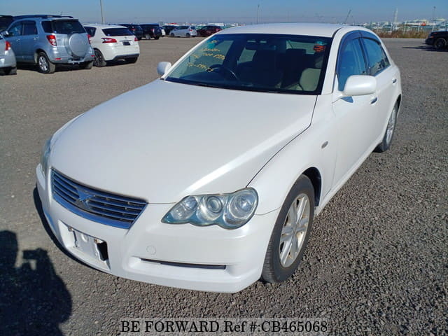A grey JDM sports car speeding down a highway at night.