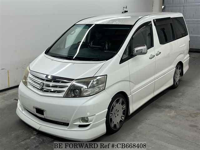 A grey JDM sports car speeding down a highway at night.