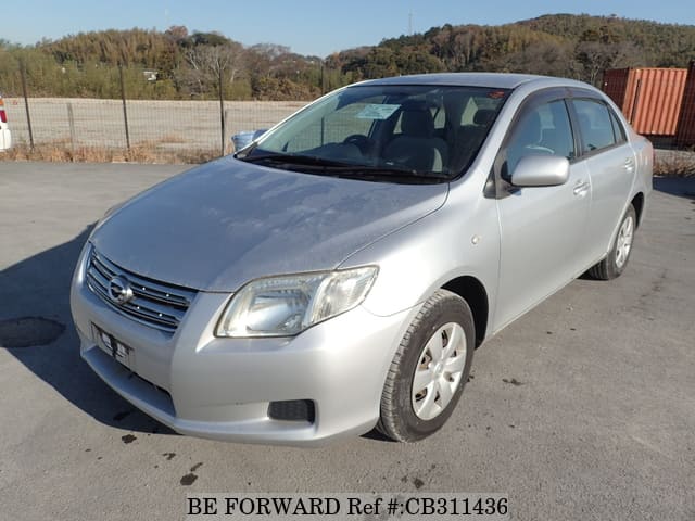 A grey JDM sports car speeding down a highway at night.