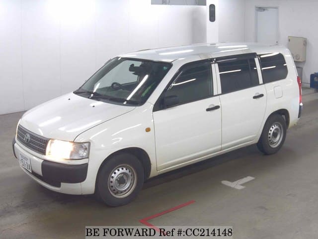 A grey sports car speeding down a highway at night.