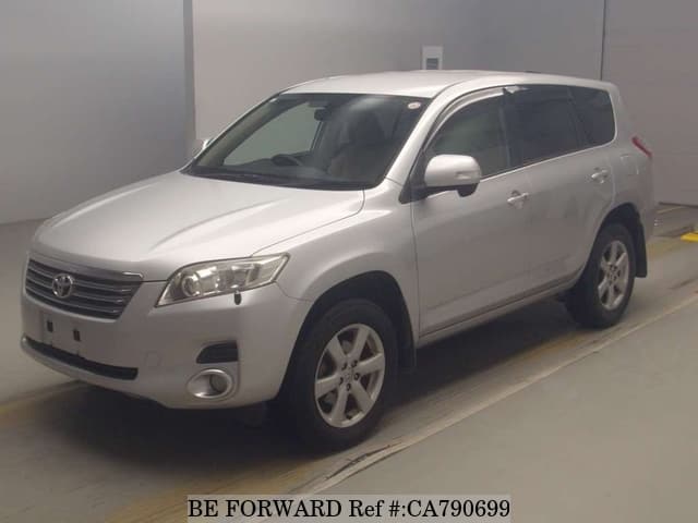 A grey JDM sports car speeding down a highway at night.