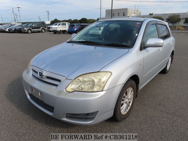 A grey JDM sports car speeding down a highway at night.