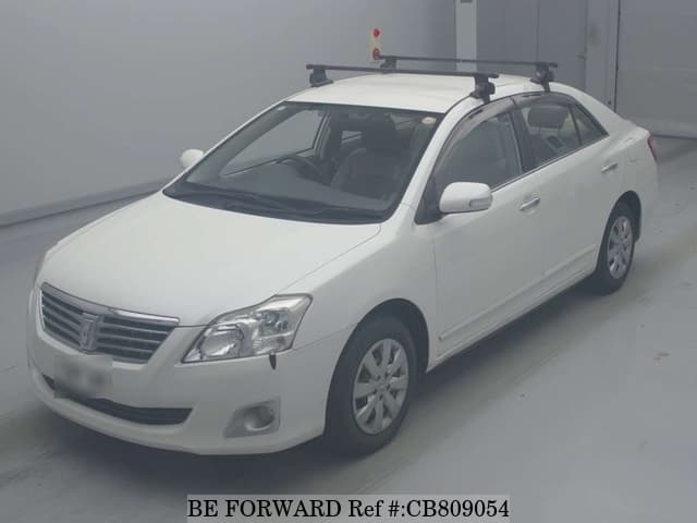 A grey JDM sports car speeding down a highway at night.