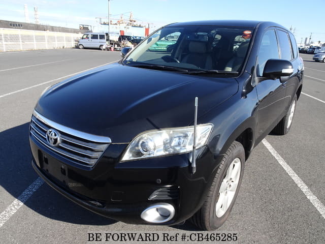 A grey JDM sports car speeding down a highway at night.