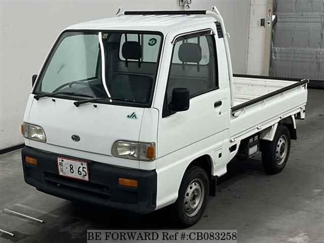 A grey JDM sports car speeding down a highway at night.