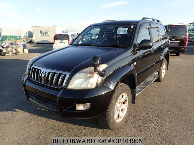 A grey JDM sports car speeding down a highway at night.
