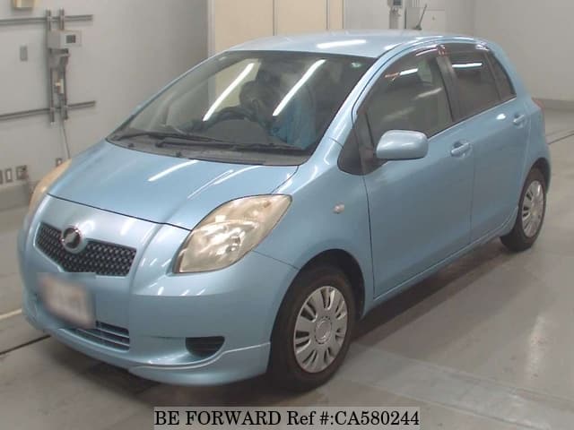 A grey JDM sports car speeding down a highway at night.