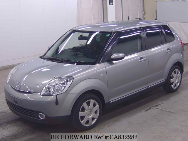 A grey JDM sports car speeding down a highway at night.