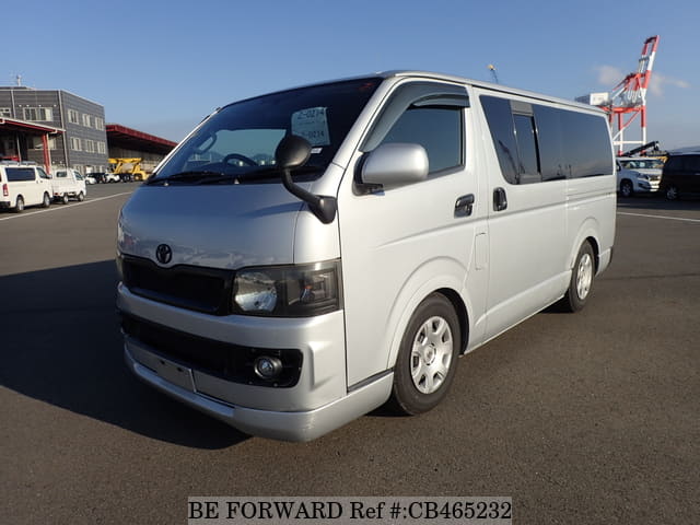 A grey JDM sports car speeding down a highway at night.