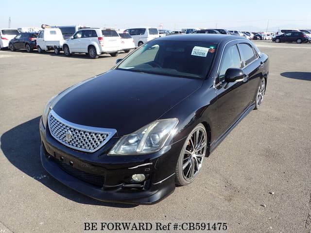 A grey JDM sports car speeding down a highway at night.
