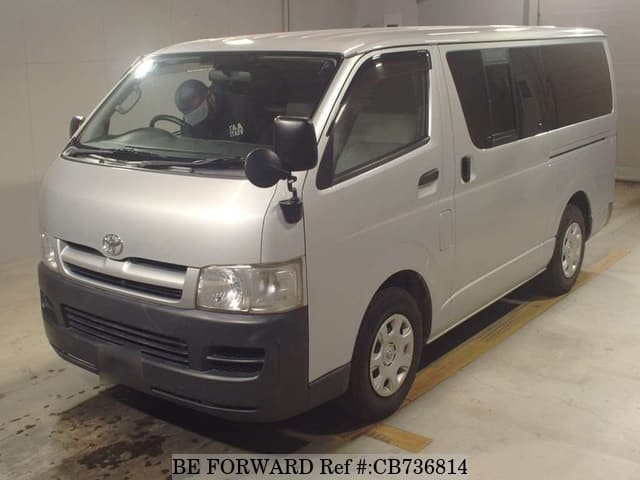 A grey JDM sports car speeding down a highway at night.