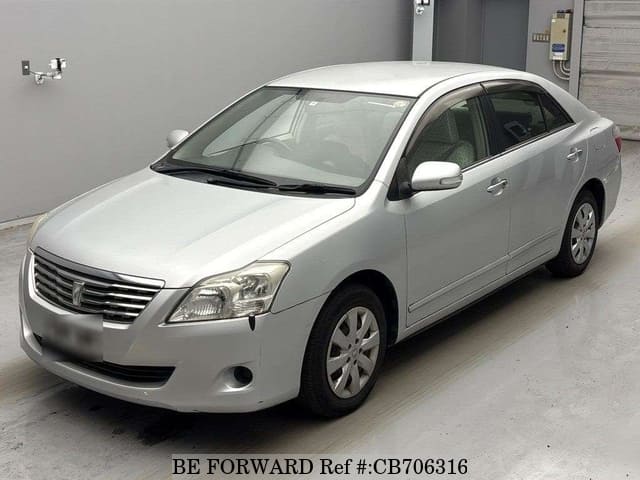 A grey JDM sports car speeding down a highway at night.