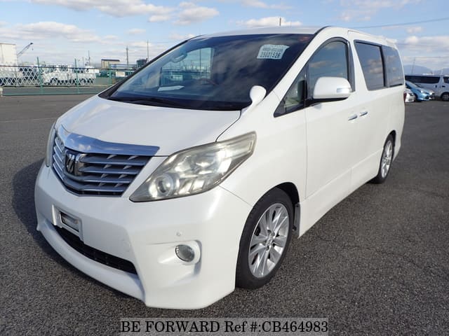 A grey JDM sports car speeding down a highway at night.