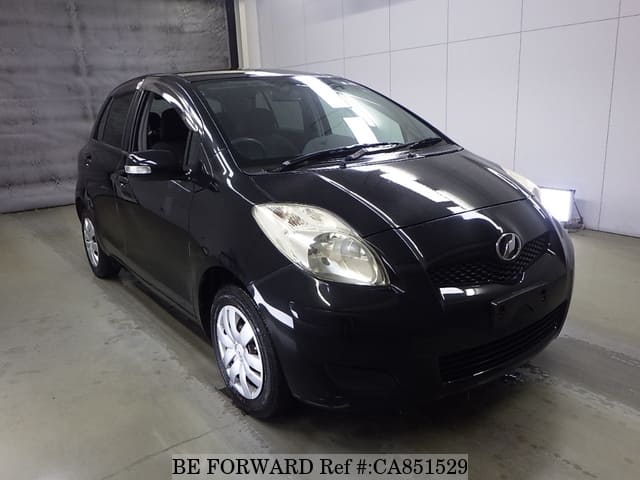 A grey JDM sports car speeding down a highway at night.
