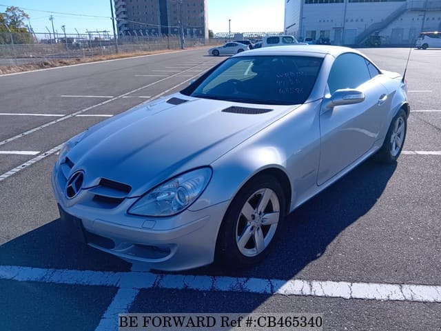A grey JDM sports car speeding down a highway at night.
