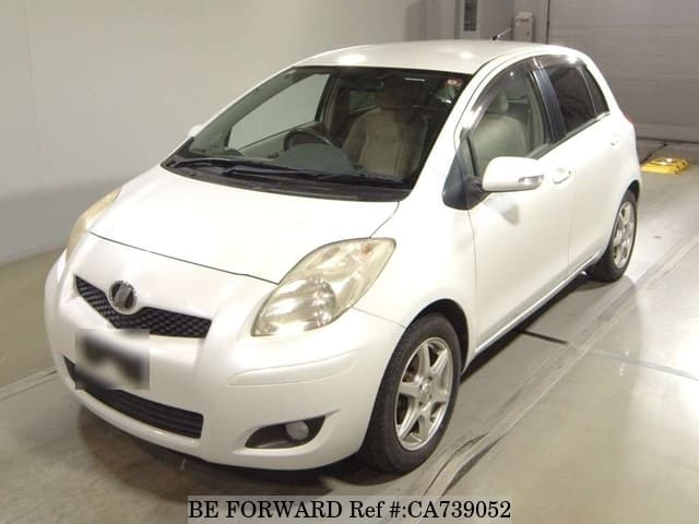 A grey JDM sports car speeding down a highway at night.