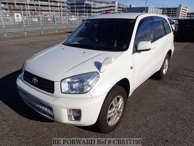 A grey JDM sports car speeding down a highway at night.