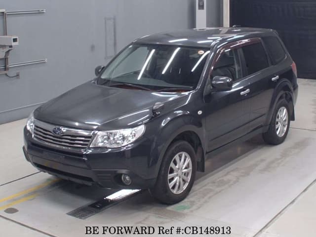 A grey JDM sports car speeding down a highway at night.