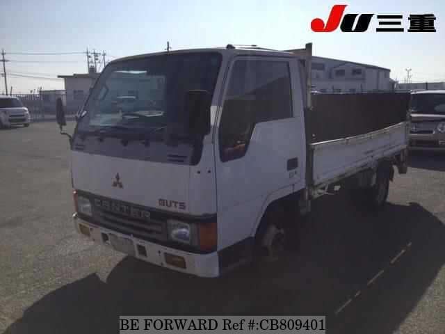A grey JDM sports car speeding down a highway at night.