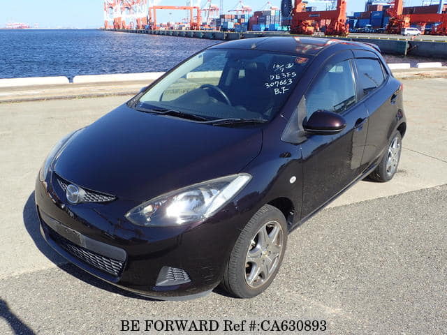 A grey JDM sports car speeding down a highway at night.