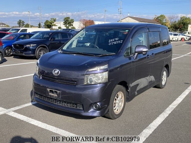 A grey JDM sports car speeding down a highway at night.