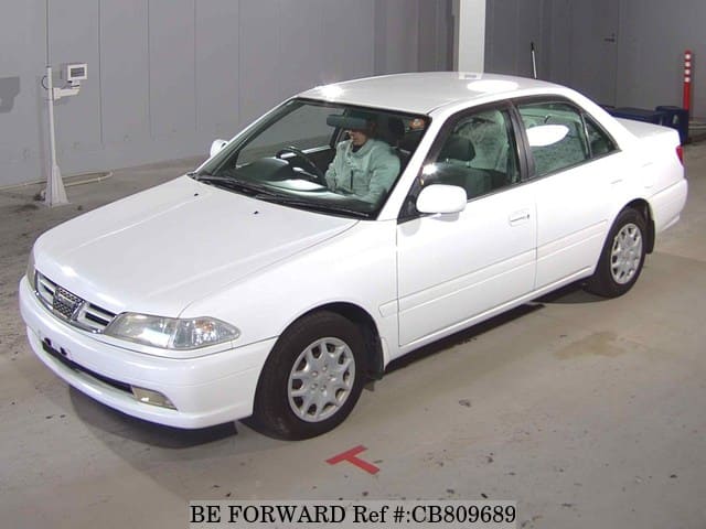 A grey JDM sports car speeding down a highway at night.