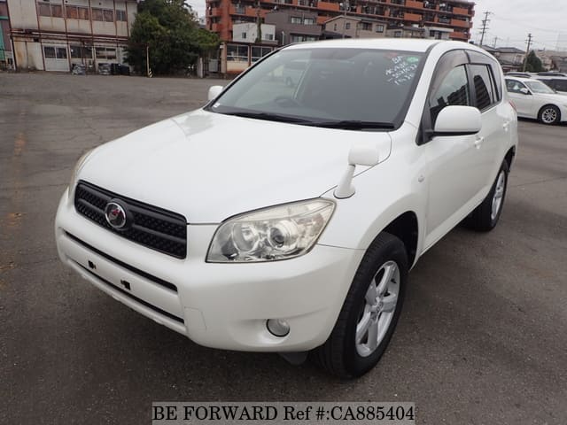 A grey JDM sports car speeding down a highway at night.