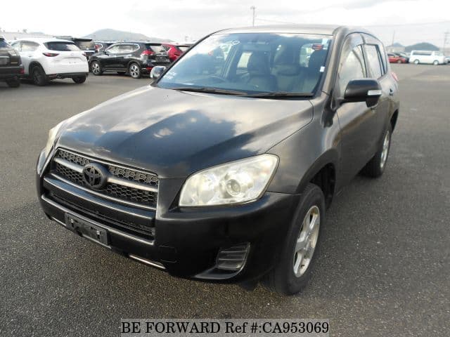 A grey JDM sports car speeding down a highway at night.