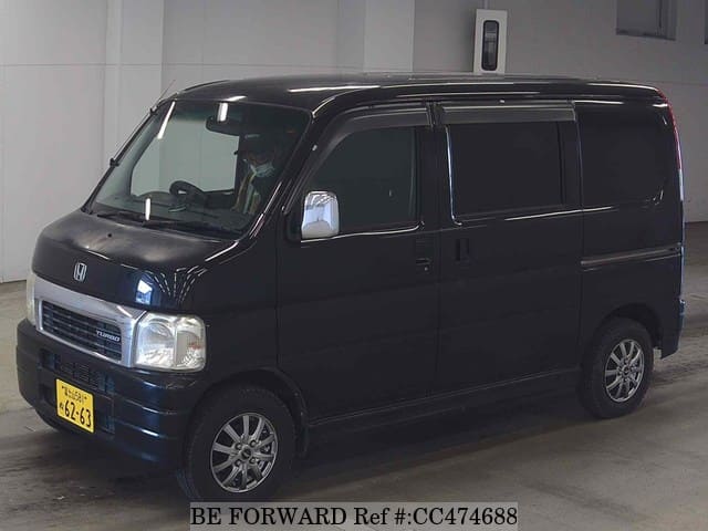 A grey JDM sports car speeding down a highway at night.