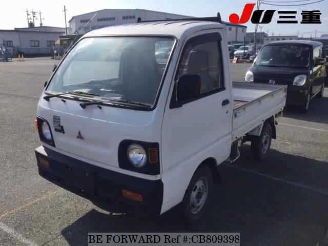 A grey JDM sports car speeding down a highway at night.