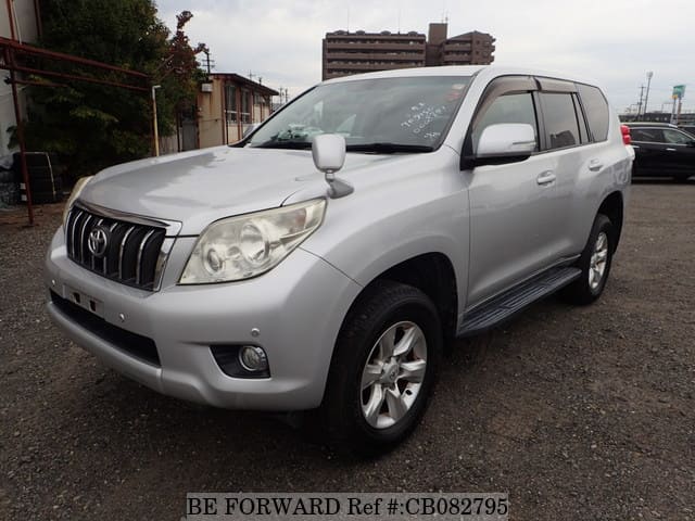 A grey JDM sports car speeding down a highway at night.
