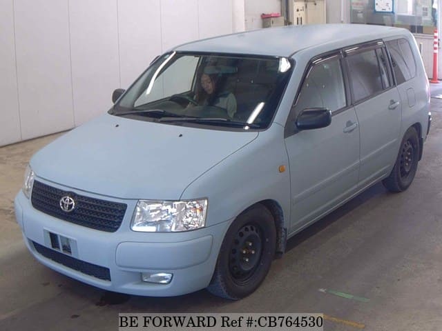 A grey JDM sports car speeding down a highway at night.