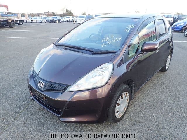 A grey JDM sports car speeding down a highway at night.