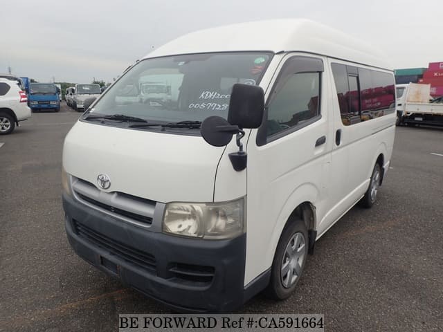 A grey JDM sports car speeding down a highway at night.