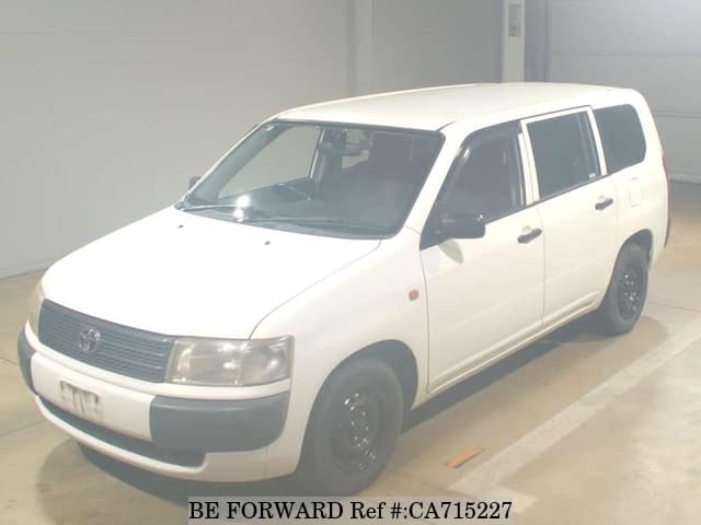 A grey JDM sports car speeding down a highway at night.