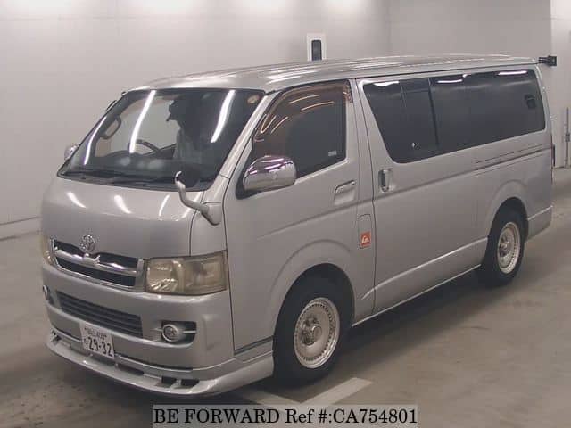 A grey JDM sports car speeding down a highway at night.